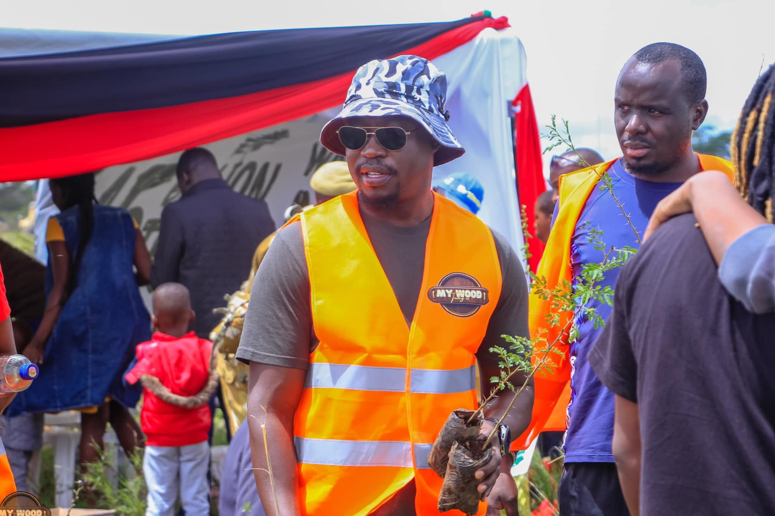 A man carrying two seedlings