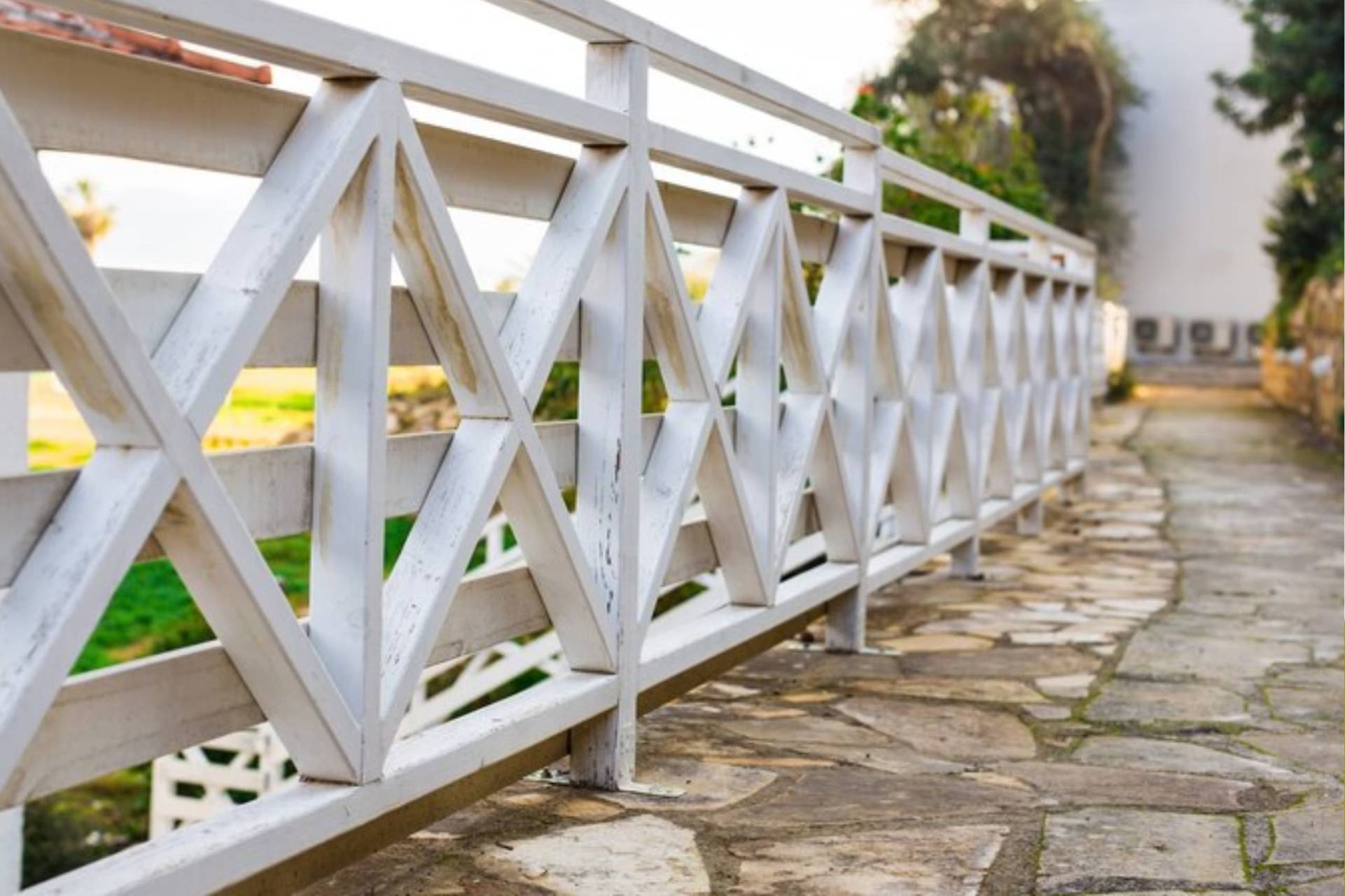 A wooden fence with white painting